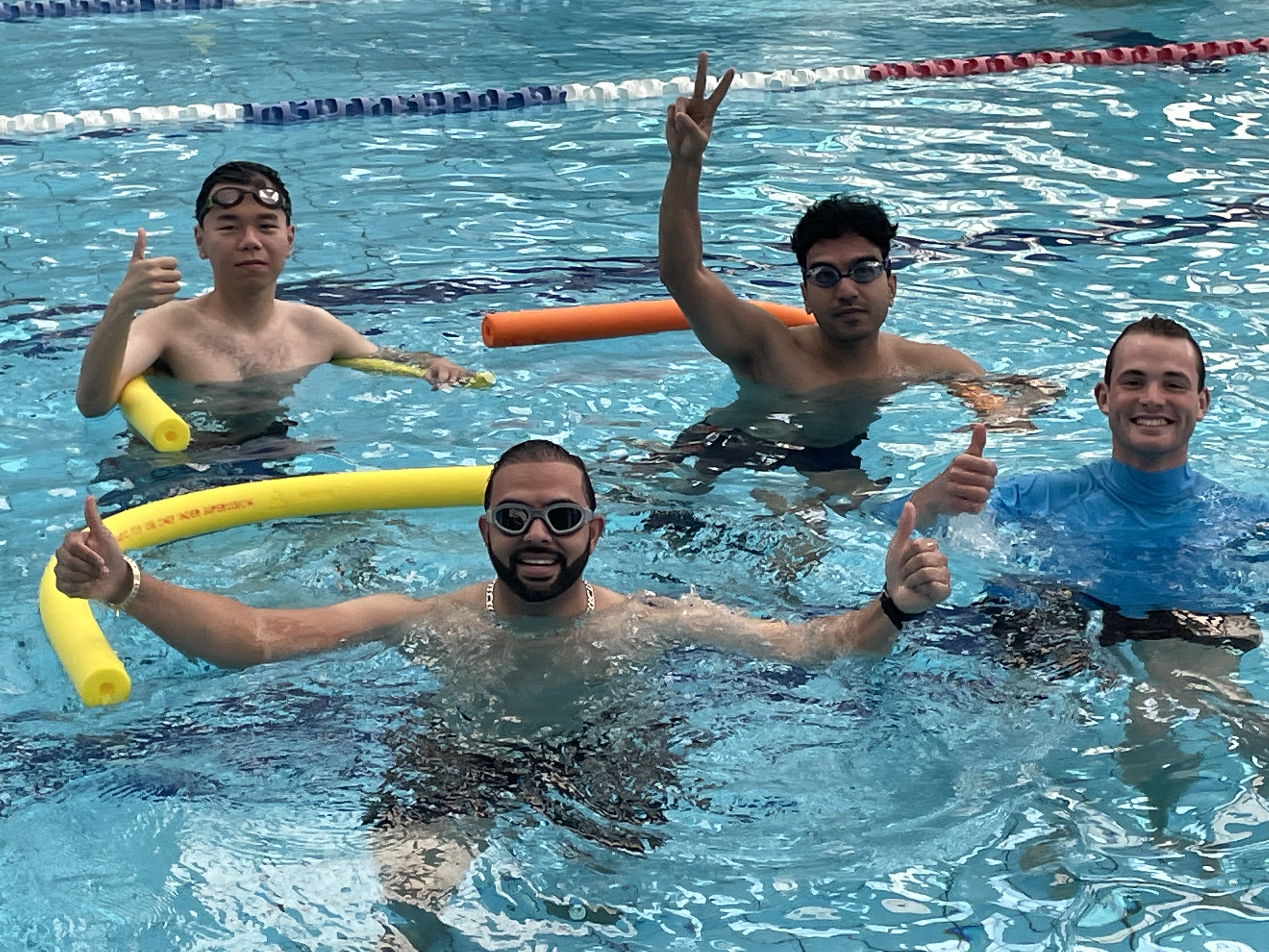 People smiling in a pool